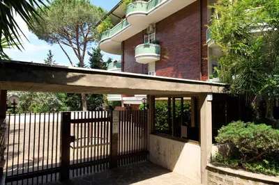 a fence in front of a house with a building at Le case di Andrea Piccolomini San Peter - Terrace Flat in Rome