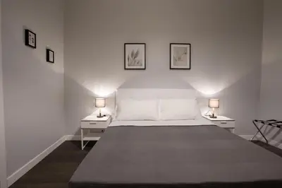 a bedroom with a bed and a desk and a television at maribea rome center in Rome