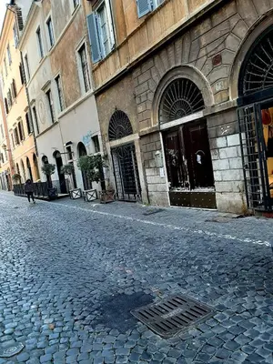 a cobblestone street in front of a building at Pellegrino 75 Double Bedroom in Rome