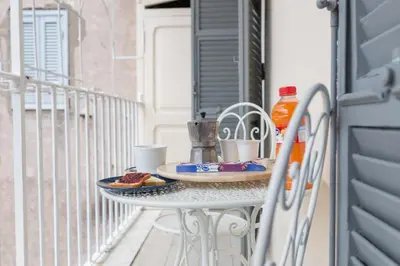 a table with food and drinks on a balcony at Pellegrino 75 Double Bedroom in Rome