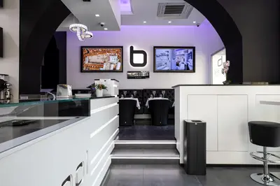 a bar in a restaurant with purple walls at THE ONE Boutique Hotel & SPA Roma in Rome