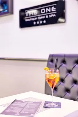 a drink in a glass sitting on a table at THE ONE Boutique Hotel & SPA Roma in Rome