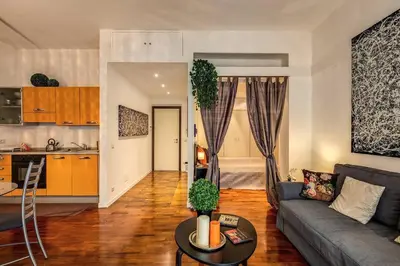 a living room with a couch and a table at Lovely apartment close Vatican in Rome