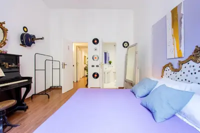 a bedroom with a large bed and a piano at Home Of Arts in the Center in Rome