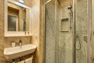 a bathroom with a sink and a shower at Colosseo Accomodation Room Guest House in Rome