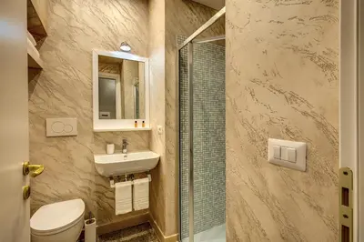 a bathroom with a toilet and a sink and a shower at Colosseo Accomodation Room Guest House in Rome