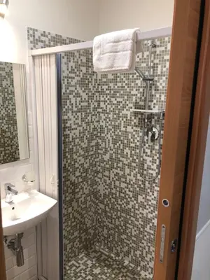 a bathroom with a shower and a sink at Rent Rooms Colosseum in Rome