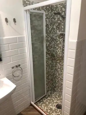 a shower with a glass door in a bathroom at Rent Rooms Colosseum in Rome