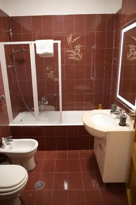 a bathroom with a toilet and a sink at Vista Cupola House in Rome