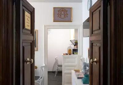 a hallway with a door open to a room with a desk at Art Atelier Borgo in Rome