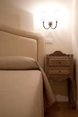 a bedroom with a bed and a nightstand with a lamp at Residenza Dei Gracchi in Rome