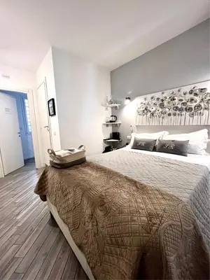a bedroom with a large bed in a room at Spagna Rooms in Rome