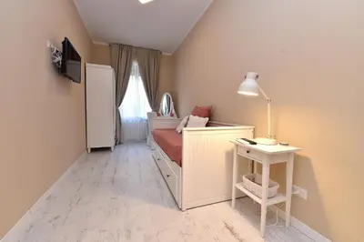 a small bedroom with a bed and a table at Jubilee 3 Luxury apartment in Rome Vatican in Rome