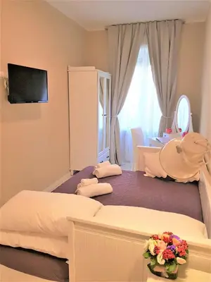 a hotel room with two beds and a mirror at Jubilee 3 Luxury apartment in Rome Vatican in Rome