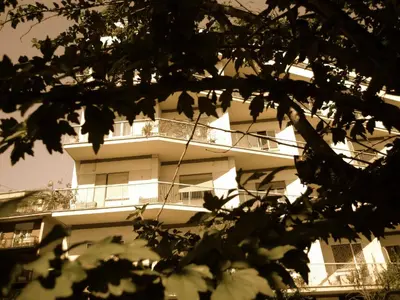 a white building with a balcony on the side of it at Alba Romana in Rome