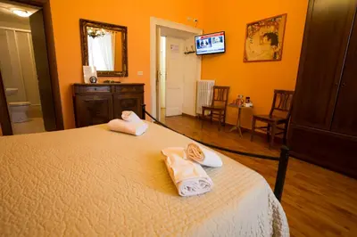 a bedroom with a bed with towels on it at Laterano Inn in Rome