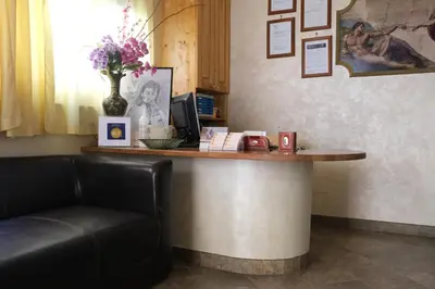 a counter in a room with a desk with a computer at B&B La Porta in Rome