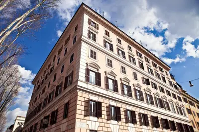 a tall brick building with a sky in the background at Residenza I Rioni Guesthouse in Rome