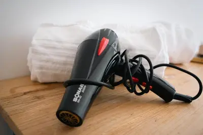a hair dryer sitting on top of a wooden table at Residenza I Rioni Guesthouse in Rome
