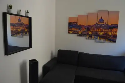 a living room with a couch and a picture on the wall at Apartment Silvestri in Rome