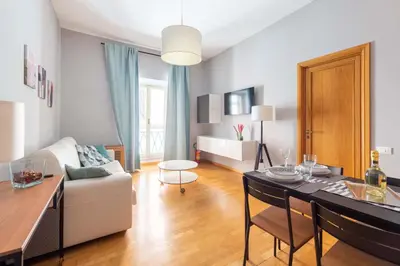 a living room with a couch and a dining room table at ELICAL Luxury Apartments in Rome