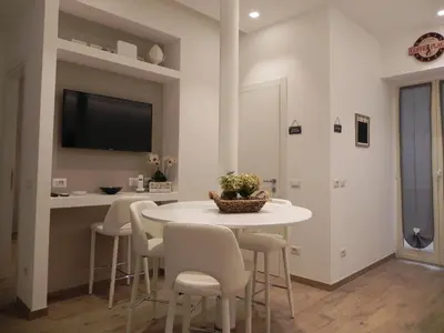 a white dining room with a white table and chairs at St. Peter's Refuge 2 in Rome