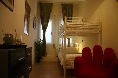 a bedroom with a bunk bed and a living room at Mila Guest House in Rome