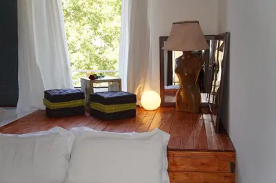 a bedroom with a bed and a lamp and a window at Jacuzzi Rooms in Rome