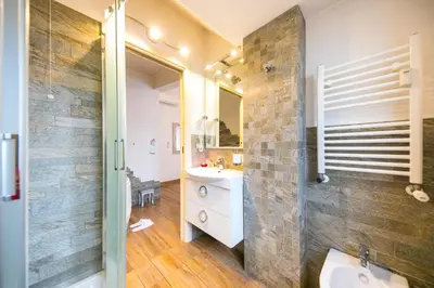 a bathroom with a sink and a mirror at Suites Roma Tiburtina Economy in Rome