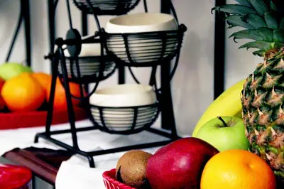 a fruit stand with bowls of fruit on a table at Suites Roma Tiburtina Economy in Rome