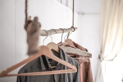 a rack of hangers with clothes on it at Coliving Trastevere in Rome