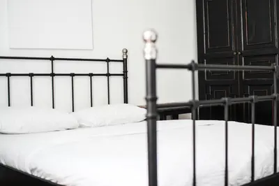 a black bed with white pillows in a bedroom at Coliving Trastevere in Rome