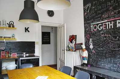 a dining room with a table and a chalkboard wall at Coliving Trastevere in Rome