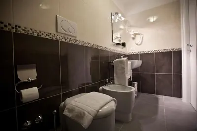 a bathroom with a toilet and a sink at Heart of Rome Rooms in Rome