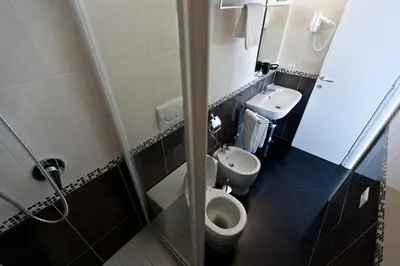 a small bathroom with a toilet and a sink at Heart of Rome Rooms in Rome