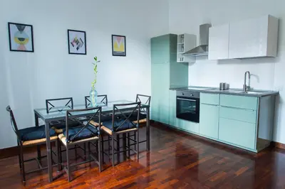 a kitchen with a table and chairs in a room at Le Naiadi in Rome