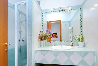a bathroom with a sink and a mirror at THE ROMAN NEST ai Musei Vaticani in Rome