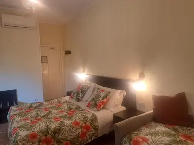a bedroom with a bed and a couch and lights at Eco B&B Marela in Rome