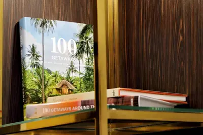 a book sitting on a shelf next to some books at BQ House Colosseo Luxury Rooms in Rome