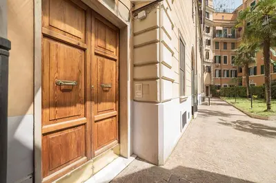 a building with a large wooden door on a street at Rome Sweet Home near Metro Flaminio in Rome
