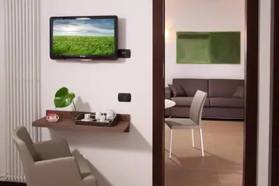 a living room with a television on a wall at Residence Hotel Parioli in Rome