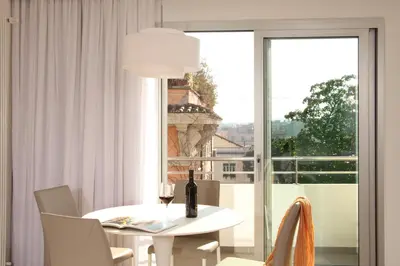 a white dining room with a table and a window at Residence Hotel Parioli in Rome