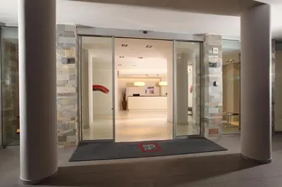 a lobby with a glass elevator in a building at Residence Hotel Parioli in Rome