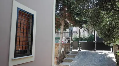 a building with a gate and a walkway at Il Giardino Al Pigneto in Rome