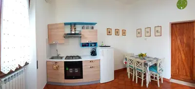 a small kitchen with a stove and a table at Il Giardino Al Pigneto in Rome