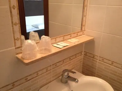 a bathroom with a sink and a mirror at Hotel Giugiù in Rome