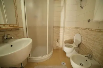 a bathroom with a sink and a toilet and a shower at Hotel Giugiù in Rome