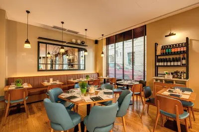 a restaurant with tables and chairs in a room at Prassede Palace Hotel in Rome
