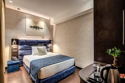 a hotel room with a bed and a desk at Prassede Palace Hotel in Rome