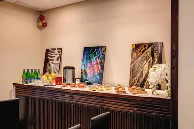 a buffet of food on a counter with paintings at Prassede Palace Hotel in Rome